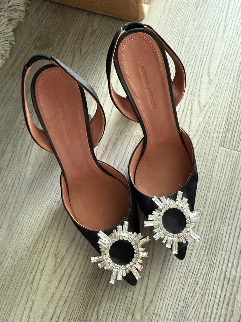 Amina Muaddi Black Slingback Pumps with Crystal Sunburst